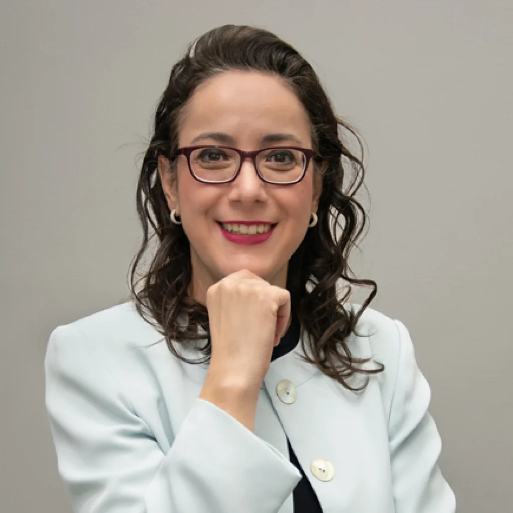 Dra. Daniela Cotta Ribeiro, dentista especialista em odontologia hospitalar e patologia bucal, sorrindo com jaleco branco em foto profissional da ZENITH Odontologia Hospitalar em Belo Horizonte